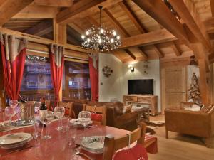 a dining room with a table and a chandelier at Superbe T6 au centre des Gets - 10 pers, 5 ch, parking, wifi, linge inclus - FR-1-685-7 in Les Gets +4 photos