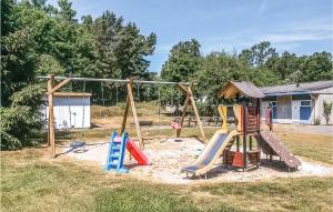 a playground with colorful slides and a swing at Cozy Apartment In Nex With Kitchen in Neksø