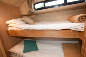 a bedroom with two bunk beds and a window at Caley Cruisers in Inverness