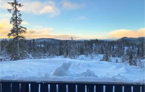 a pile of snow with a tree in the background at Stunning Home In Aurdal With House A Mountain View in Aurdal