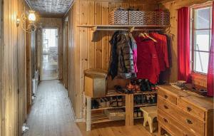 a room with a wooden wall with a closet with shoes at Stunning Home In Aurdal With House A Mountain View in Aurdal