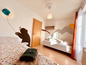 1 dormitorio con 2 camas y un osito de peluche en la pared en Landhaus Alpenzeit, en Arzl im Pitztal