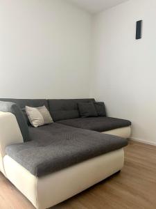 a couch in a room with a white wall at Wohnung am Wald in Geisa