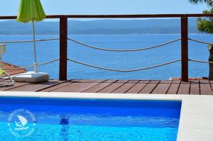 a swimming pool with a view of the ocean at Apartments Mistral in Mimice