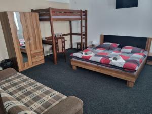 a bedroom with two bunk beds and a couch at Pension Max Klínovec in Loučná pod Klínovcem +25 photos