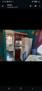 a kitchen with a white refrigerator in a kitchen at Cabaña cómoda 1 dormitorio in Coihaique