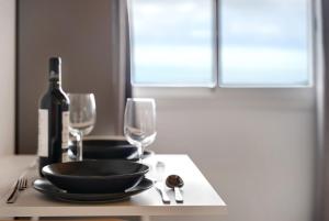 a table with a bottle of wine and two wine glasses at Casa Lomo el Aire Sterlizia in Tegueste