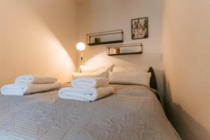 Un dormitorio con una cama con toallas blancas. en Staylight Cozy Appartement, ruhig und citynah gelegen, Netflix, Premium Ausstattung, en Celle