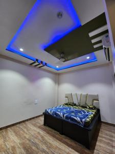 a room with a bed and a blue ceiling at Holiday Home in Ujjain