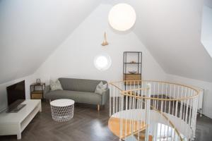 a living room with a staircase and a couch at Ferienwohnung Zschopau Zentrum in Zschopau