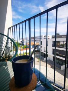 a cup of coffee sitting on a table on a balcony at Modern apartment with balcony and free parking in Porto