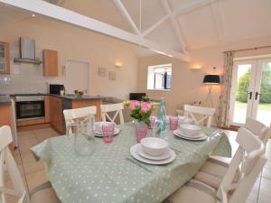 a dining room with a table and a kitchen at 2 bed property in Shaftesbury 28678 in Sedghill