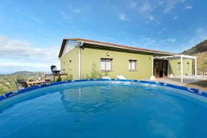a villa with a pool in front of a house at Casa Lomo el Aire Brezo in Tegueste