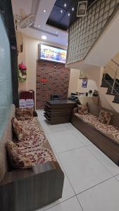 a room with three beds in a store at Kesari root in Amritsar