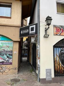a store with a sign on the side of a building at Kristina NS in Novi Sad