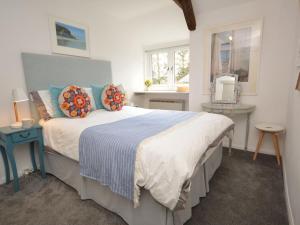 a bedroom with a large bed with pillows on it at 1 bed in Boscastle 42375 in Saint Gennys
