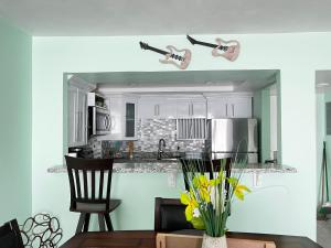 a kitchen with two guitars hanging from the ceiling at SEAFLECTIONS in Kingston