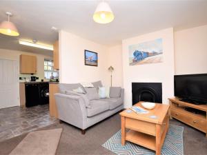 a living room with a couch and a television at 1 Bed in Wymondham 43278 in Wymondham