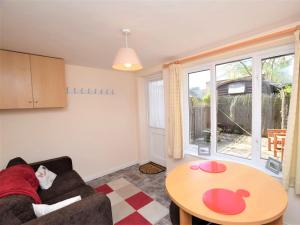 a living room with a couch and a table at 1 Bed in Wymondham 43278 in Wymondham