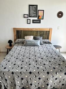a large bed in a bedroom with several pictures on the wall at El Porteño in San Pedro