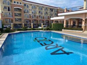 a large swimming pool in front of a building at Condo Rentals in Arezzo - 1 Br Condo in Davao City