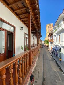 a balcony of a building with people walking down a street at Hotel Casa Agustina in Cartagena de Indias