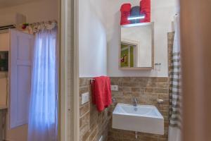 a bathroom with a sink and a mirror at B&B Tulip Lotus Castelbuono in Castelbuono +20 photos