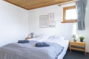 a bedroom with two beds with blue pillows on them at Chasa Fabulusa in Scuol
