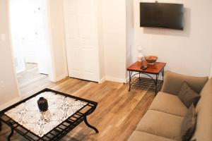 a living room with a couch and a table at 2BR - Parking - 5 Min to North Shore! in Pittsburgh
