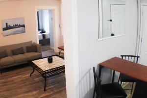 a living room with a couch and a table at 2BR - Parking - 5 Min to North Shore! in Pittsburgh