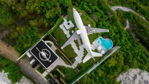 an aerial view of a house with a plane at Private Jet Villa Uluwatu in Uluwatu