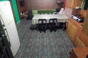a table in a kitchen with a table and chairs at LE Transient Homes - SC in Baguio