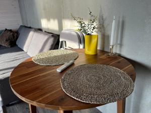 a wooden table with two hats on top of it at Cottage with Seaview in Holbæk