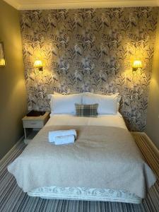 a bedroom with a bed with two towels on it at The Ardingly Inn in Ardingly