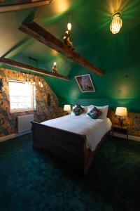 a bedroom with a large bed in a green room at Kip 23 JJs Emsworth in Emsworth