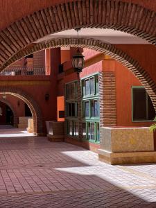 an archway in a building with a brick courtyard at Peaceful Apartment: Hivernage,Guéliz in Marrakesh