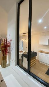 a mirror on top of a counter in a room at Nice and cosy flat near Geneva or Annecy in Bellegarde-sur-Valserine