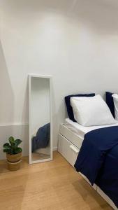 a bedroom with a mirror next to a bed at Nice and cosy flat near Geneva or Annecy in Bellegarde-sur-Valserine