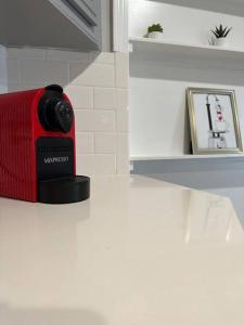 a red bag sitting on a counter next to a picture at Elegant 1 Bdr-Montrose_ Siena @The Italian Plaza in Houston