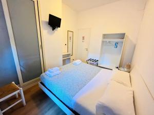 a small room with a bed and a small refrigerator at Porta Amari B&B in Palermo +68 photos