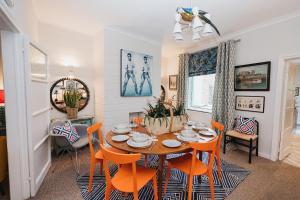 a dining room with a table and orange chairs at Hoole House in Chester