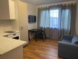 a kitchen and living room with a table and a couch at convenient and comfortable accommodation in Tallinn