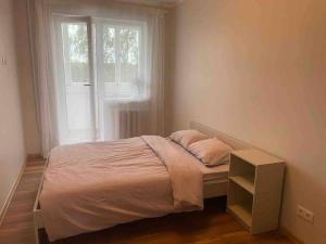 a bed in a bedroom with a window at convenient and comfortable accommodation in Tallinn