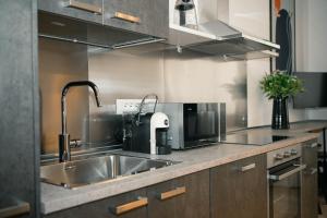 a kitchen with a sink and a microwave at Black Marble - Design Apartment in Bari