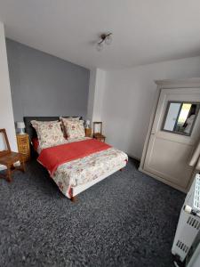 a bedroom with a bed and a window and a door at Gite en pleine verdure au coeur du village in Lapoutroie