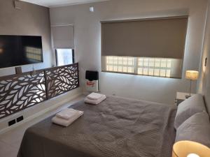 מיטה או מיטות בחדר ב-Belgrano Apart