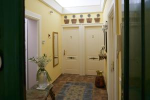 a hallway with a door and a vase of flowers at B&B Domvs tva in Chieti