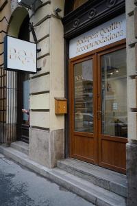a store front with a wooden door on a building at K33- Boutique Apartments, Best Location, by BQA in Budapest