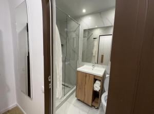 a bathroom with a sink and a shower and a toilet at Sulimen Camp in Tengiz