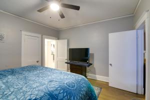 um quarto com uma cama e uma televisão de ecrã plano em Charming Home 2 Mi to Downtown Memphis and Zoo em Memphis